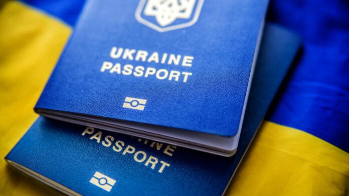 Ukrainian biometric passports on the background of the Ukrainian blue yellow flag