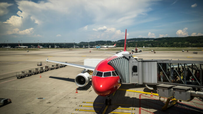 Commercial flight aircraft in airport with passangers boarding