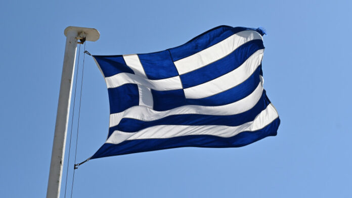 Greek national flag against a blue sky