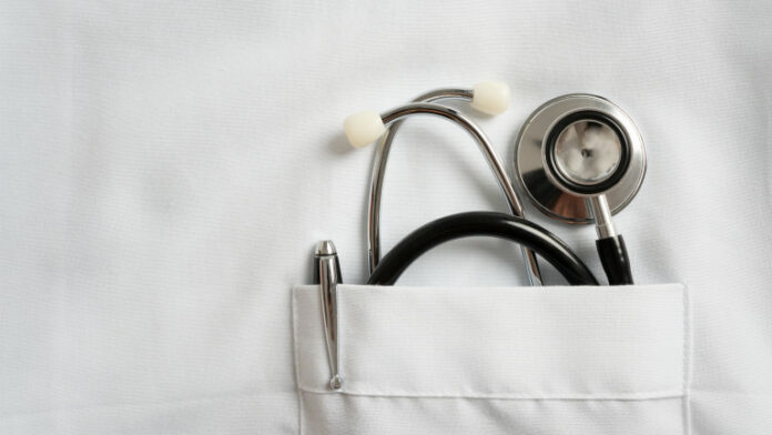 stethoscope and pen in doctor robe pocket