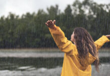 Обилен дъжд зарадва Плевен! Back view of a carefree woman on rain by the river