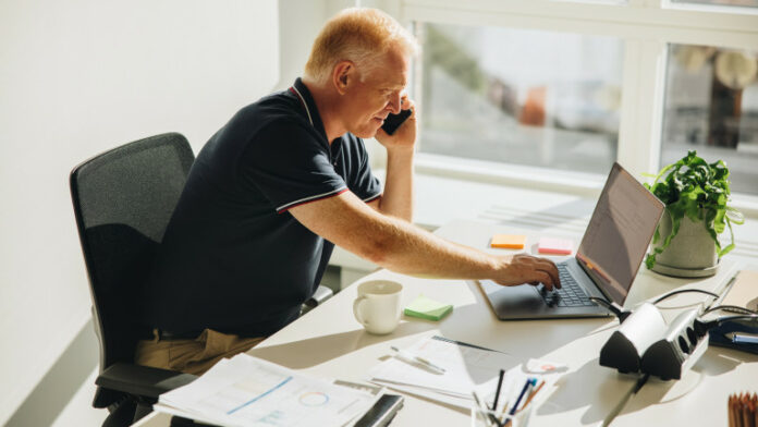 Senior business professional working at his desk